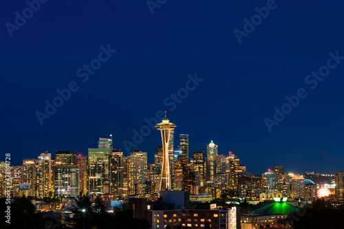 Seattle skyline panorama with iconic view observation tower called Space Needle as seen from Kerry Park. Skyscrapers of financial downtown at night  Washington  USA. A vibrant business neighborhood