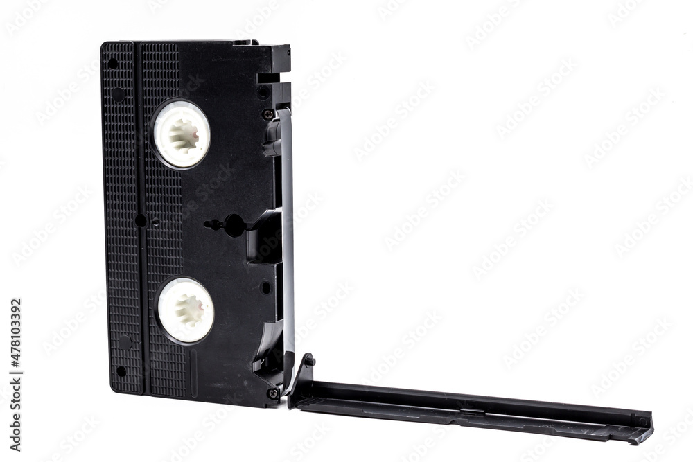 Old VHS cassette with broken tape cover isolated on white