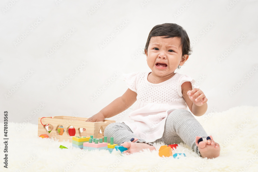 Asia little girl is crying, dissatisfied, needs the love of her parents. Asia little girl is crying, dissatisfied, needs the love of her parents.
