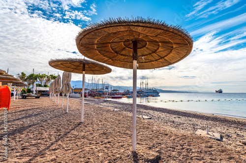 Relaxing facilities and pleasure motorboats on sandy beach of Eilat - famous ...