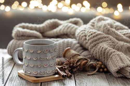 Beautiful christmas cup and candles on blurred background with bokeh.