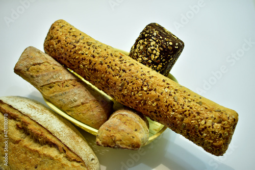 Still life composed of several loaves of bread on a white background.