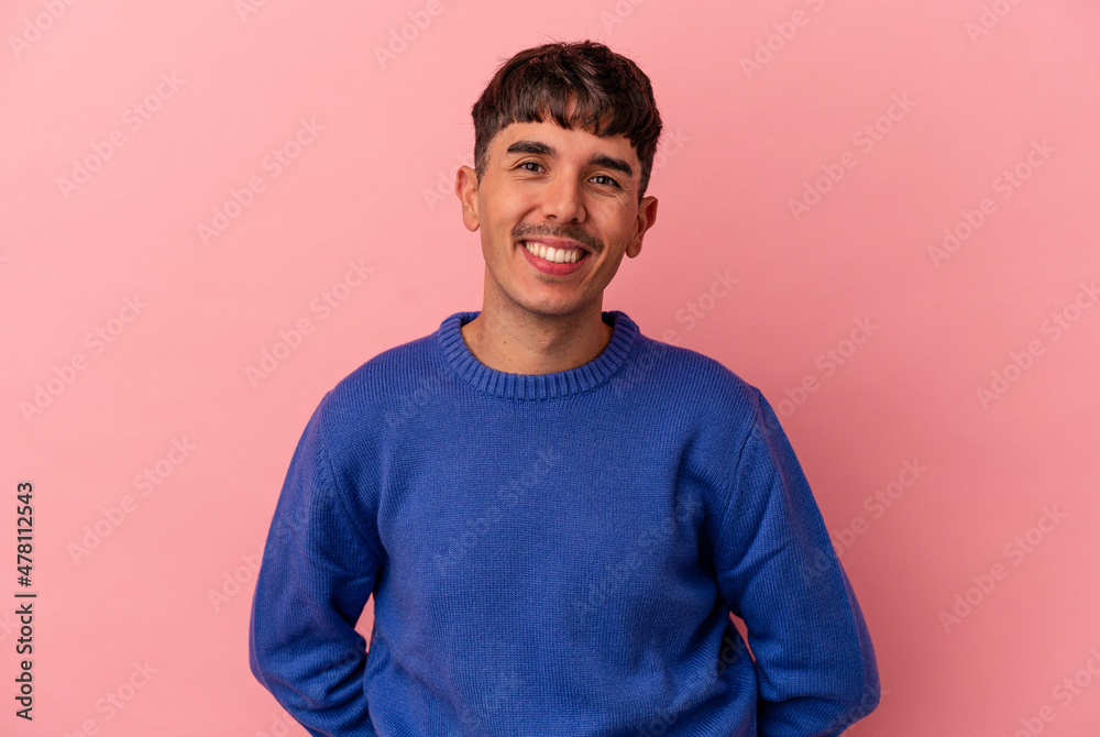 Young mixed race man isolated on pink background happy, smiling and cheerful. Young mixed race man isolated on pink background happy, smiling and cheerful.