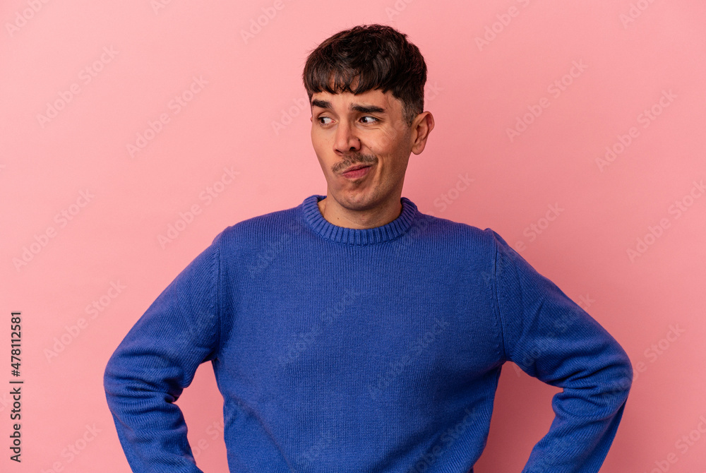 Young mixed race man isolated on pink background confused, feels doubtful and unsure. Young mixed race man isolated on pink background confused, feels doubtful and unsure.