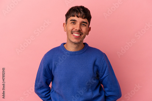 Young mixed race man isolated on pink background happy, smiling and cheerful.
