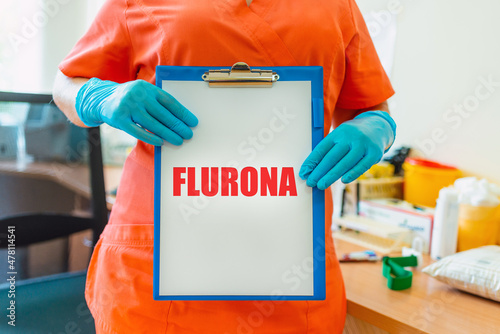 Inscription Flurona Coronavirus infection Covid-19 and flu. Text and lab or laboratory.Scientist holds inscription.Selective focus. photo