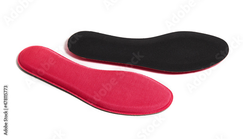 Red memory foam insoles isolated on white background. The insoles adapt to the anatomy of the foot and ensure an ideal distribution of the foot sole’s pressures. 