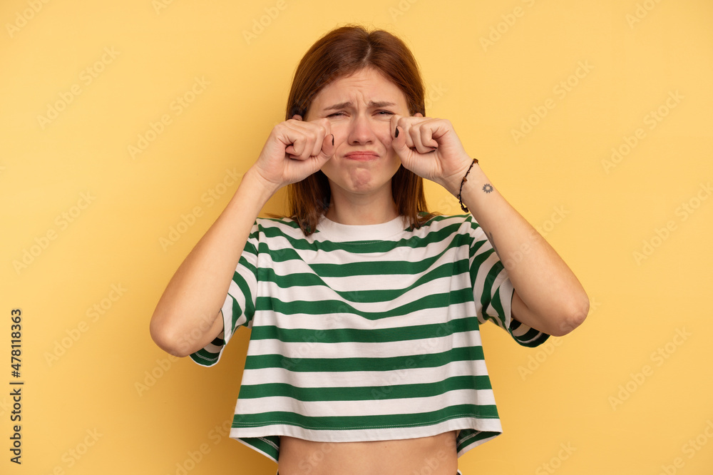 Young English woman isolated on yellow background whining and crying disconsolately. Young English woman isolated on yellow background whining and crying disconsolately.