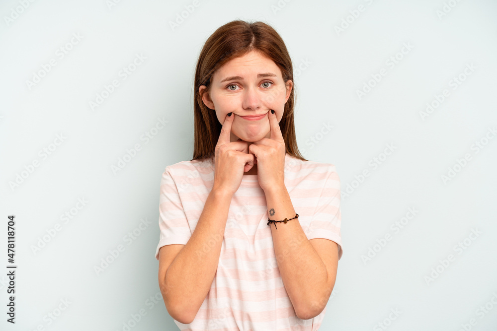 Young English woman isolated on blue background doubting between two options. Young English woman isolated on blue background doubting between two options.