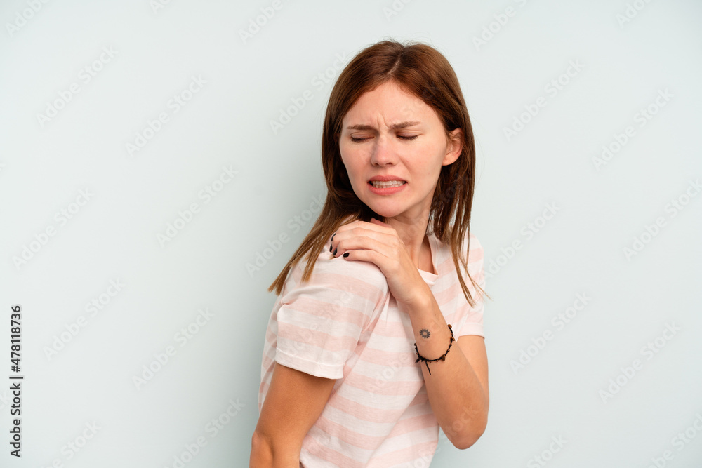 Young English woman isolated on blue background having a shoulder pain. Young English woman isolated on blue background having a shoulder pain.