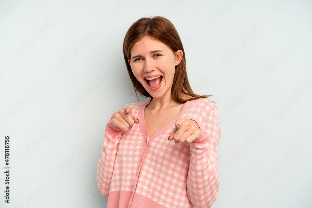 Young English woman isolated on blue background pointing to front with fingers. Young English woman isolated on blue background pointing to front with fingers.