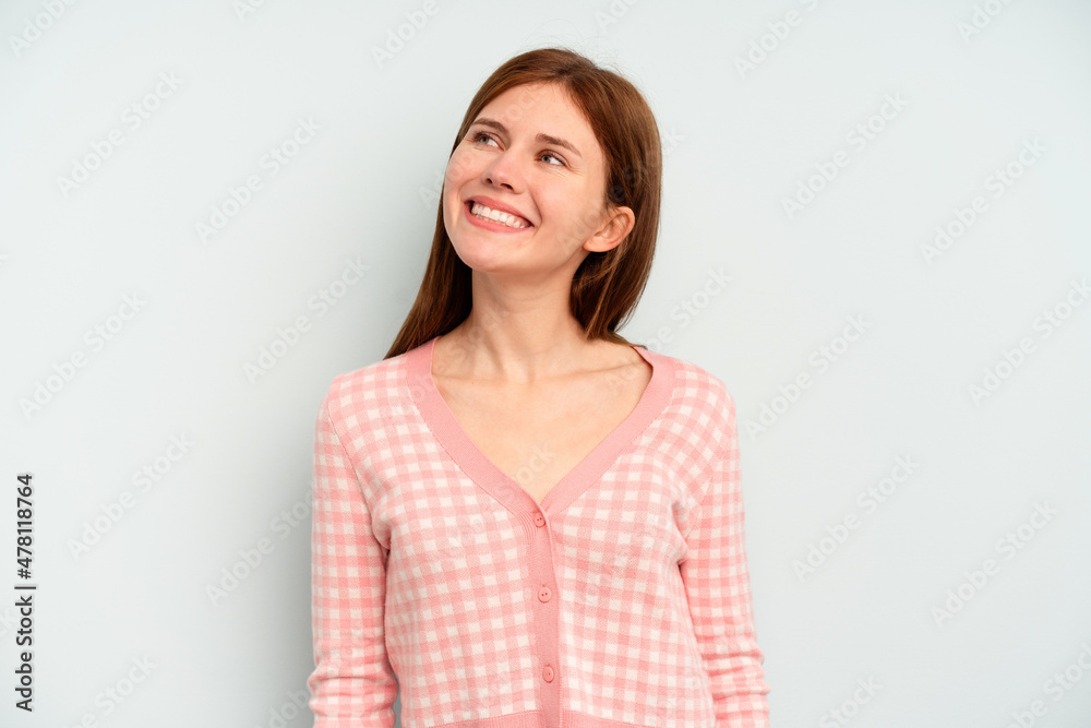Young English woman isolated on blue background relaxed and happy laughing, neck stretched showing teeth. Young English woman isolated on blue background relaxed and happy laughing, neck stretched showing teeth.