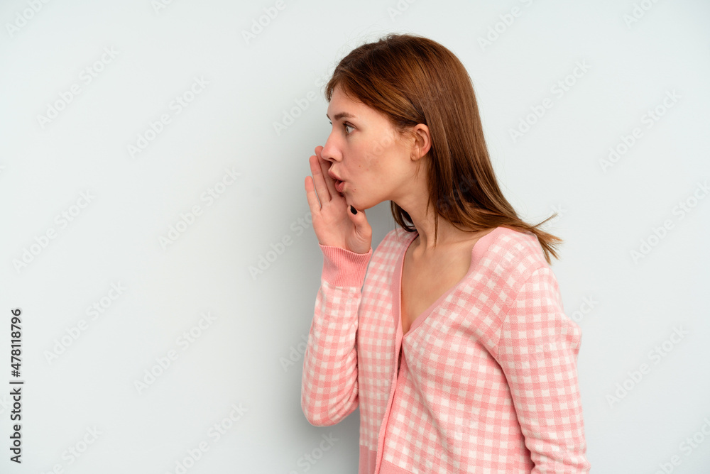 Young English woman isolated on blue background is saying a secret hot braking news and looking aside Young English woman isolated on blue background is saying a secret hot braking news and looking aside