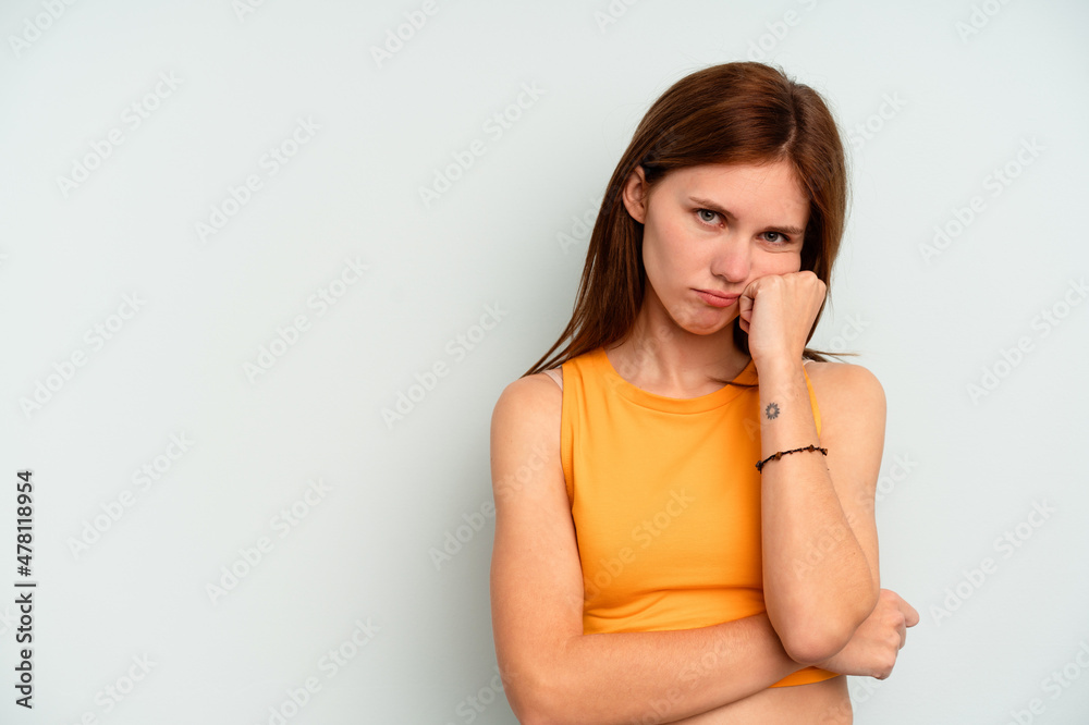 Young English woman isolated on blue background who feels sad and pensive, looking at copy space. Young English woman isolated on blue background who feels sad and pensive, looking at copy space.