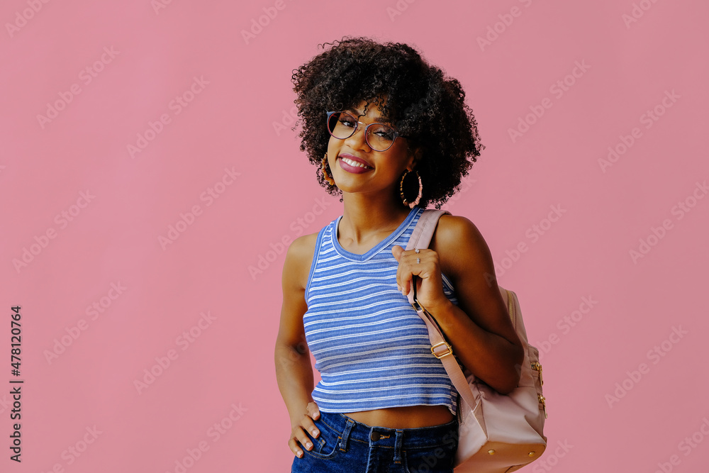 beautiful smiling girl in eyeglasses with backpack posing on pink background, back to school concept beautiful smiling girl in eyeglasses with backpack posing on pink background, back to school concept