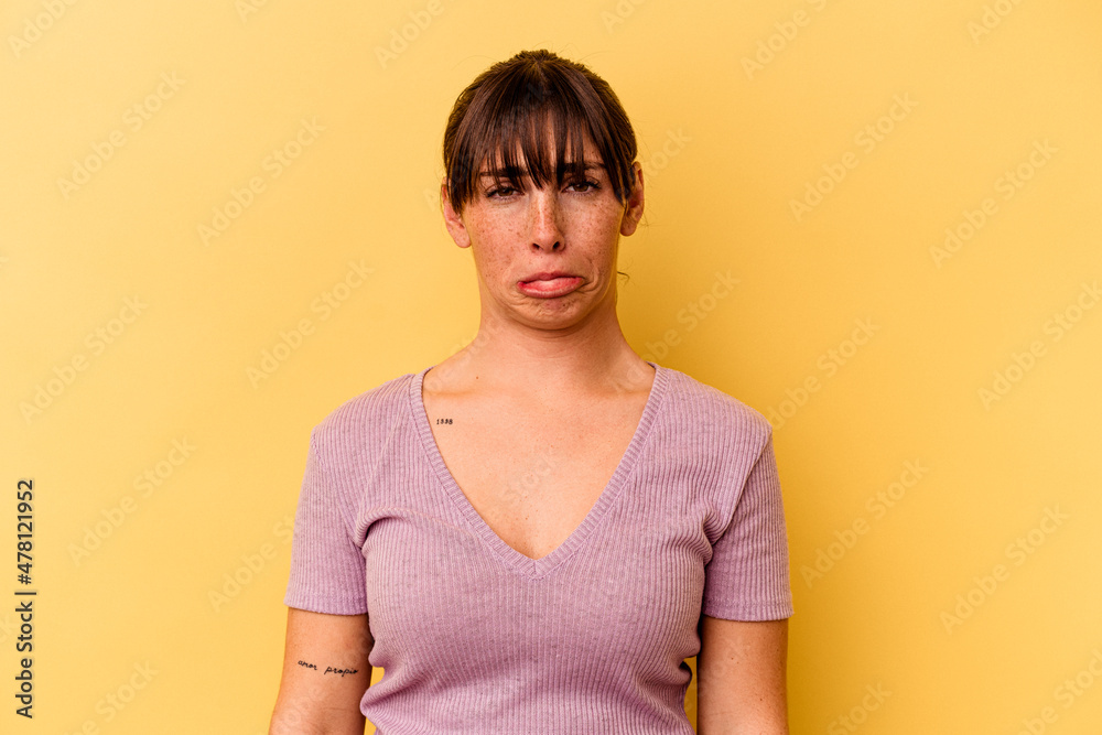 Fototapeta premium Young Argentinian woman isolated on yellow background sad, serious face, feeling miserable and displeased.