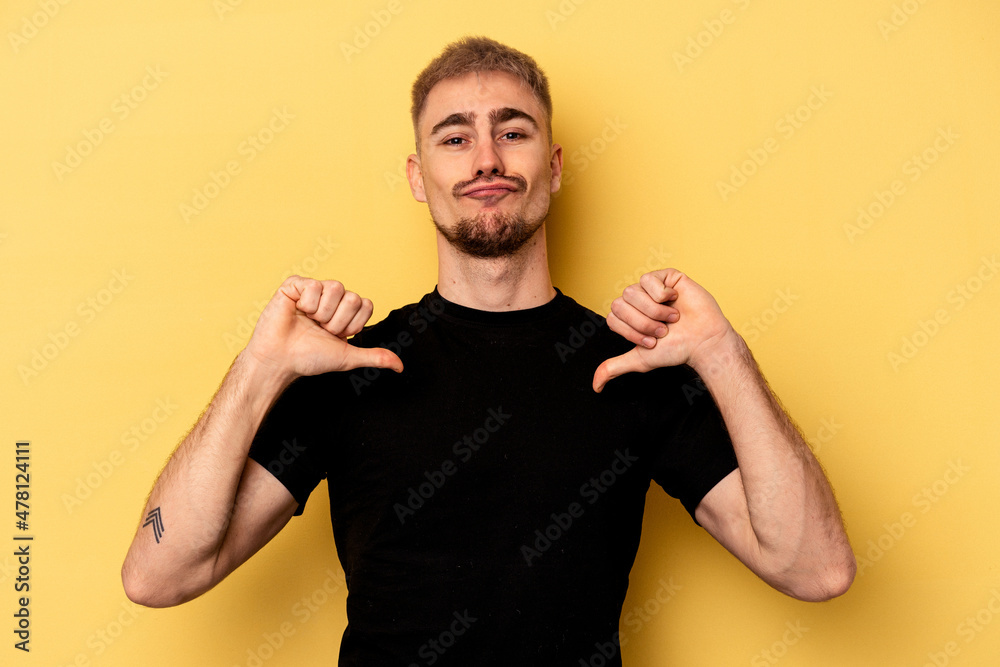 Young caucasian man isolated on yellow background feels proud and self confident, example to follow. Young caucasian man isolated on yellow background feels proud and self confident, example to follow.