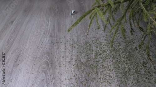 Christmas decorations fall to the floor in slow motion. the needles of the Christmas tree are crumbling. dry christmas tree