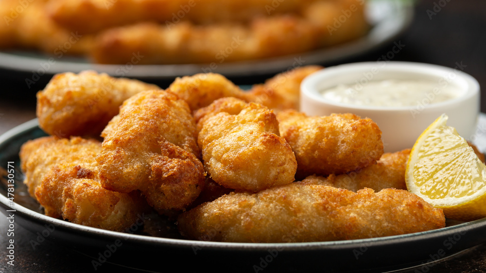 Crispy Fish strips with tartar sauce in a plate Crispy Fish strips with tartar sauce in a plate