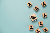 Top view design on blue background of Hand shaking which print screen on wooden cube block which connection with human icon for business deal and agreement concept.