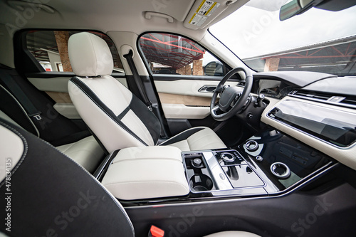 Modern luxury prestige car interior  dashboard  steering wheel. Orange red car interior.
