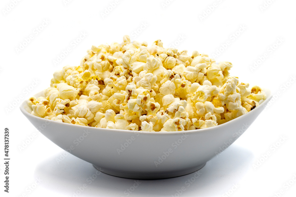 Popcorn on a white background. Fresh popcorn in ceramic bowl. Close-up. Horizontal view Popcorn on a white background. Fresh popcorn in ceramic bowl. Close-up. Horizontal view