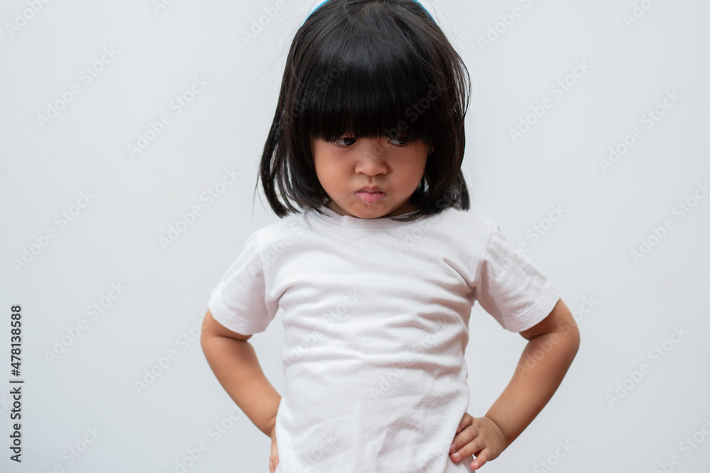 Portrait of Asian angry and sad little girl on white isolated background, The emotion of a child when tantrum and mad, expression grumpy emotion. Kid emotional control concept Portrait of Asian angry and sad little girl on white isolated background, The emotion of a child when tantrum and mad, expression grumpy emotion. Kid emotional control concept