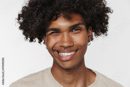 Young black man with piercing smiling and winking at camera