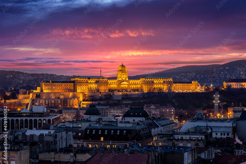 Elevated view of the illuminated Castle of Budapest, Hungary, dunring dusk with a colorful sky