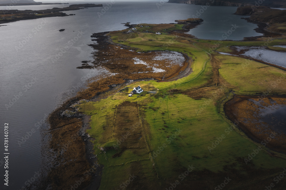 Aerial view of Isle of Skye with dramatic clouds and weather, a farm house on a small island surrounded by water