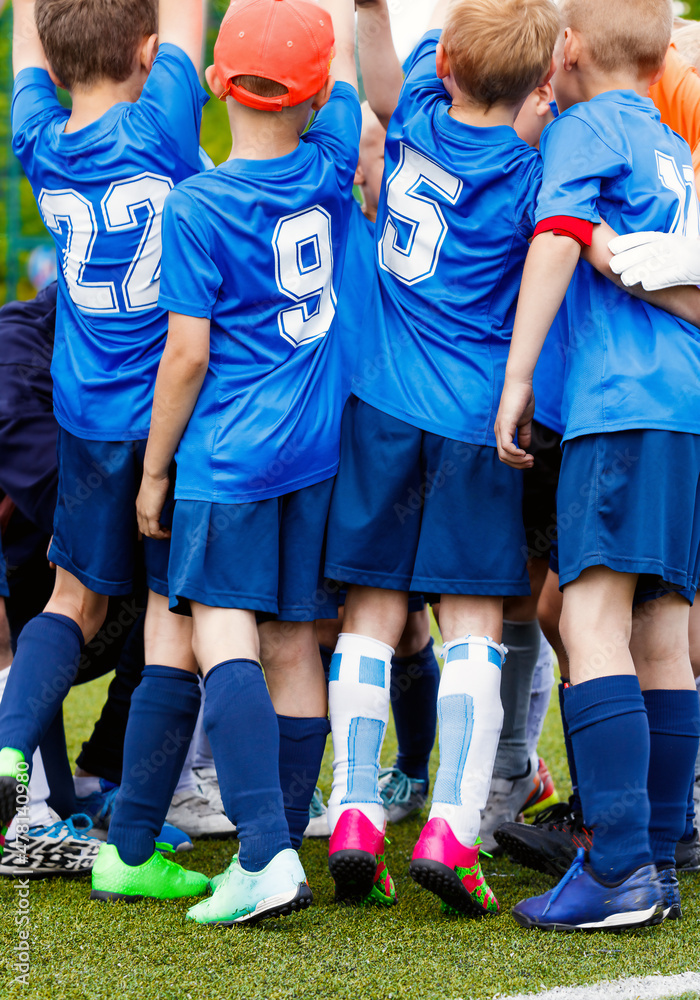 Vertical picture of happy boys in sports team celebrating success ...