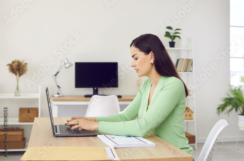 Millennial Caucasian girl student type on laptop study online at home. Young woman work on internet on computer at workplace. Distant job or education. Modern technology, communication concept.
