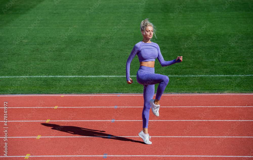 lady jumping in fitness sportswear. warm up on outdoor arena. training and workout. athletic female coach. woman sport trainer. healthy sporty lifestyle. health and energy. dieting