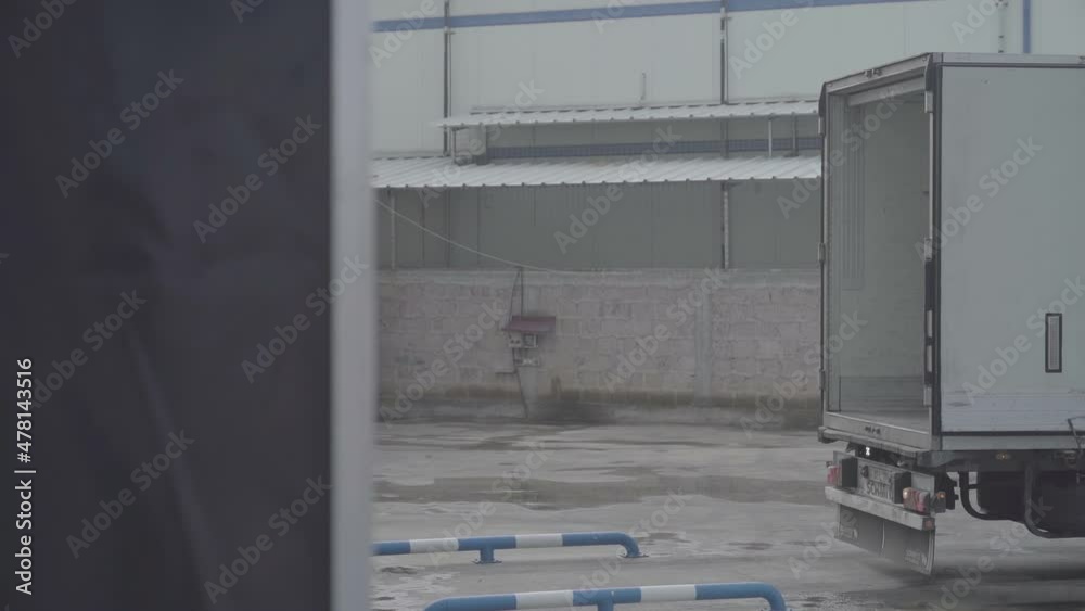Yerevan, Armenia - September, 2021: The truck is backing up to the warehouse door. Slow Motion 100 fps