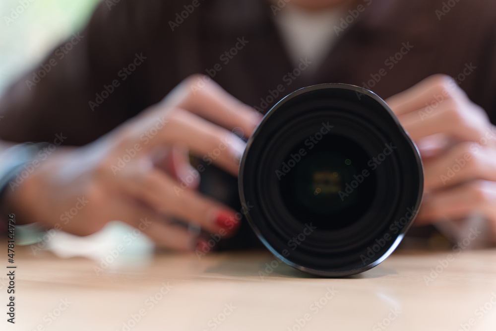 Hand adjusting modern professional camera Hand adjusting modern professional camera