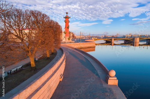 Saint Petersburg embankment. Russia bridges. Palace Bridge on winter day. Blue sky in winter Saint Petersburg. Rostral columns on spit of Vasilievsky Island. Petersburg travel. Russia city landscape. photo