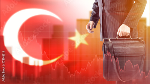 Fototapeta Naklejka Na Ścianę i Meble -  Turkish currency crisis. Exchange value of money to Turkey. Turkish republic flag with crisis charts. Economic devaluation in Turkey. Devaluation of financial system in Turkey. Man with suitcase