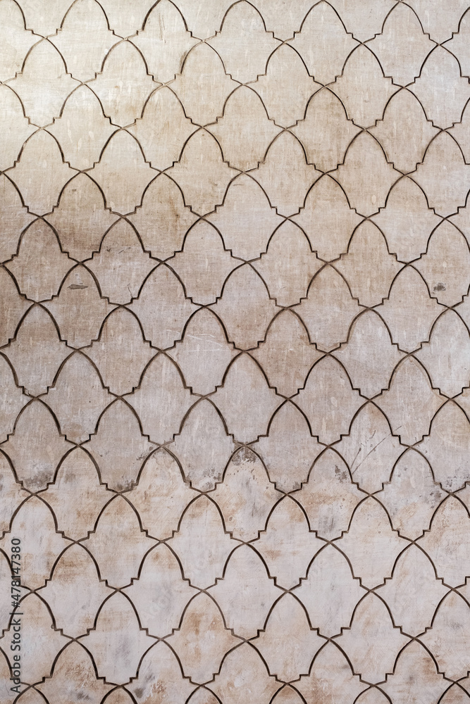 Fototapeta premium Arabic pattern on carved into stonewall
