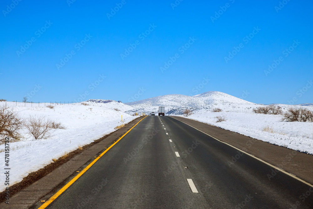 The scenery of a valley after a snowstorm, trees forest snowy road of Interstate 17 in Arizona The scenery of a valley after a snowstorm, trees forest snowy road of Interstate 17 in Arizona