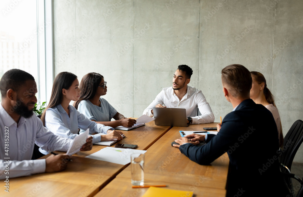 Corporate Meeting. Group Of Multiethnic Business People Having Discussion In Conference Room Corporate Meeting. Group Of Multiethnic Business People Having Discussion In Conference Room