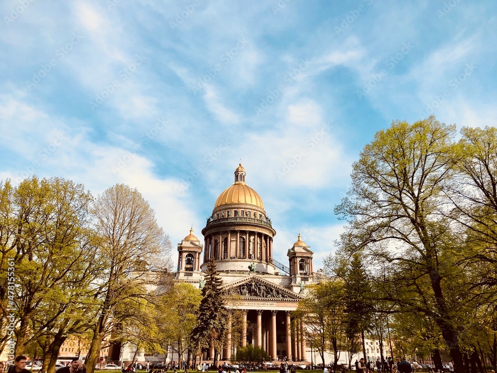 St. Isaac's Cathedral in St. Petersburg on a summer day and tree garden