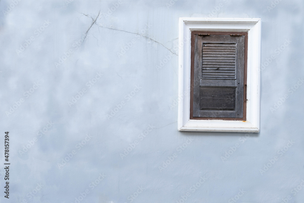 Fototapeta premium Old blue concrete wall and closed windows. Vintage wooden window on the wall.