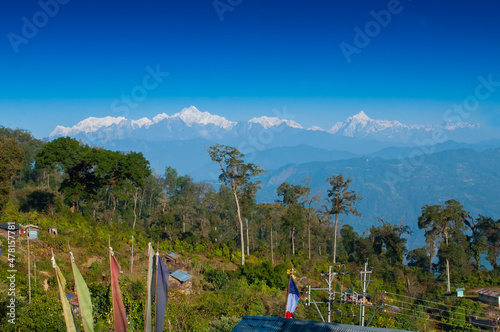 Beautiful view of Silerygaon Village with Kanchenjunga mountain range at the background, morning light, at Sikkim, India photo