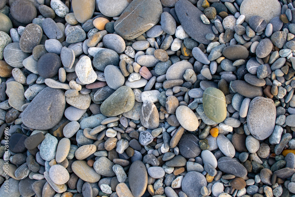 Pebble beach on the coast of Pitsunda in Abkhazia. A clean beach of colored marble pebbles. Resort beach. Tranquil seascape in pastel colors. Pebble beach on the coast of Pitsunda in Abkhazia. A clean beach of colored marble pebbles. Resort beach. Tranquil seascape in pastel colors.