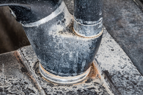 Limescale on black water tap.