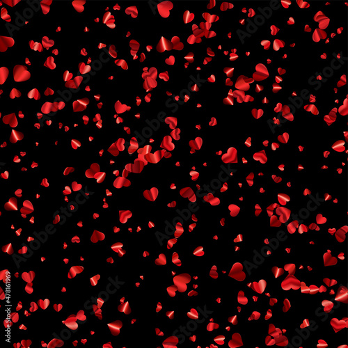 Red hearts confetti on black background.