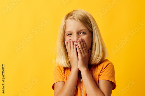 little blonde girl holding her head emotions surprise