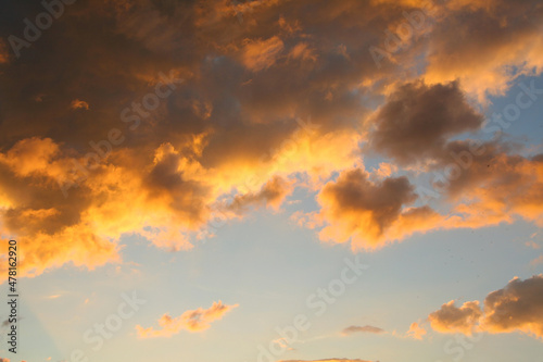 Sky with an orange cloud at sunset or sunrise. © Uilia