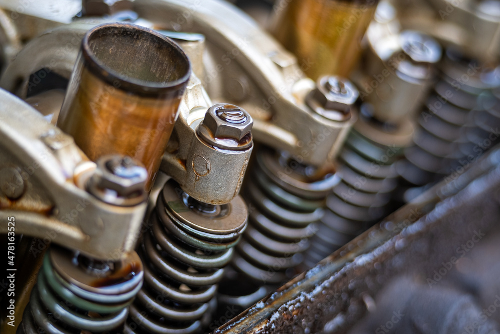 Close up Arm valve rocker of Single Over Head Camshaft engine.Car maintenance Checking and adjusting valves clearance. Close up Arm valve rocker of Single Over Head Camshaft engine.Car maintenance Checking and adjusting valves clearance.