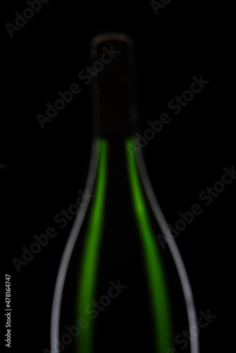 Green Champagne bottle graphically presented on black background